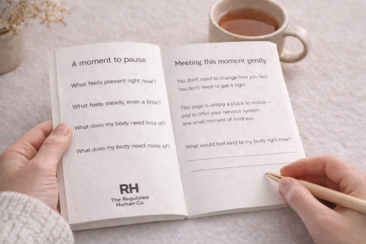 Open book with meditation prompts on a table with a cup of tea
