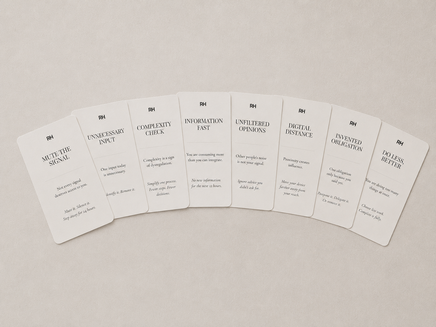 Set of white cards with black text on a beige background