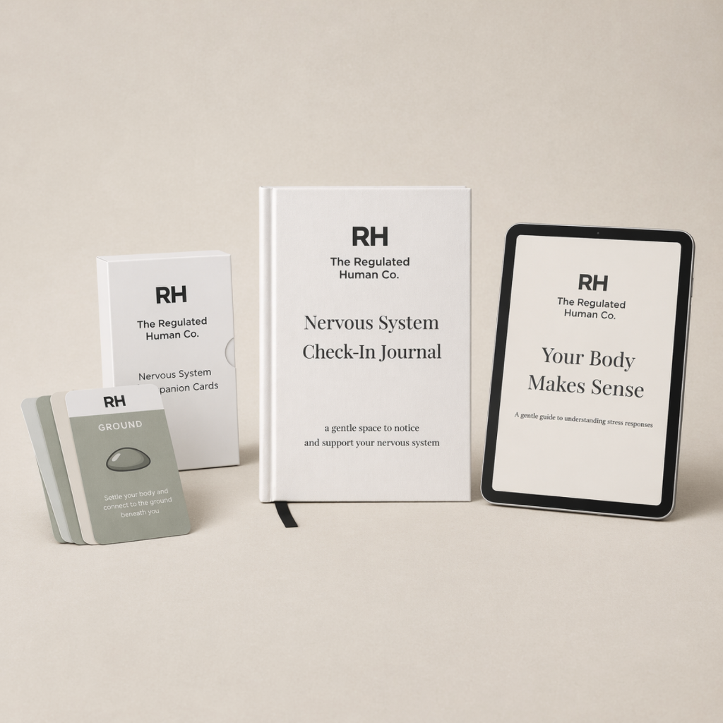 Collection of 'The Regulated Human Co.' products including a book, cards, and a tablet on a beige background.